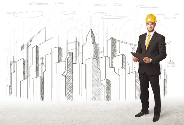 Engineer man with building city drawing in background — Stock Photo, Image