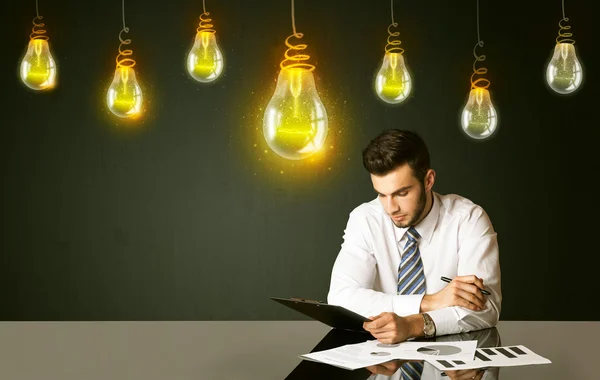 Businessman with idea bulbs — Stock Photo, Image