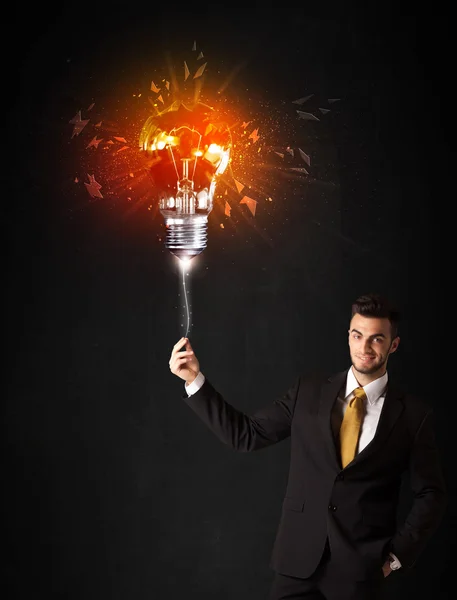 Businessman with an explosion bulb — Stock Photo, Image
