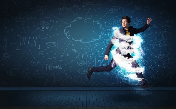 Happy business man jumping with storm cloud around him — Stock Photo, Image