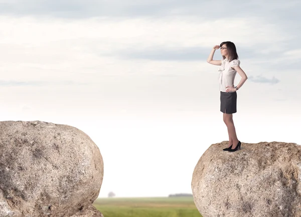 Businesswoman on rock mountain — Stock Photo, Image