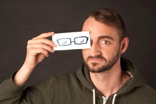 Happy guy looking with paper hand drawn eye glasses — Stock Photo, Image