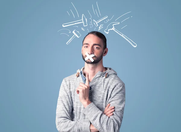 Young man with glued mouth and beating hammer marks — Stock Photo, Image