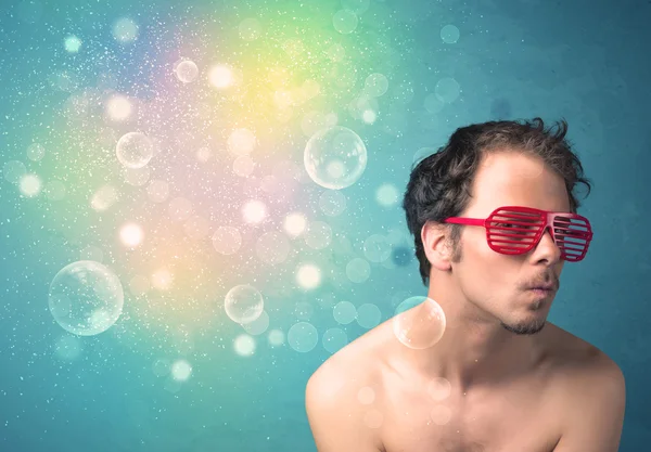 Young man with sunglasses and bokeh colourful lights — Stock Photo, Image