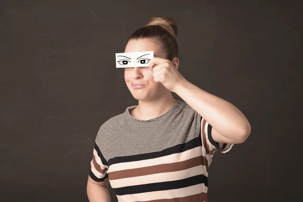 Silly youngster looking with hand drawn eye paper — Stock Photo, Image