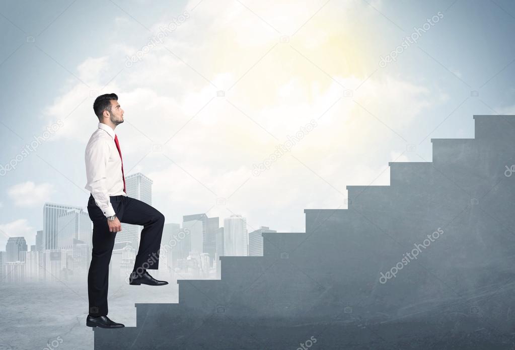 Businessman climbing up a concrete staircase concept