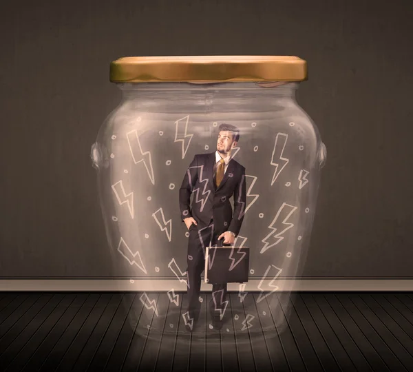 Businessman inside a glass jar with lightning drawings concept — Stock Photo, Image