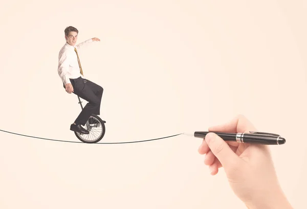 Businessman riding monocycle on a rope drawn by hand — Stock Photo, Image