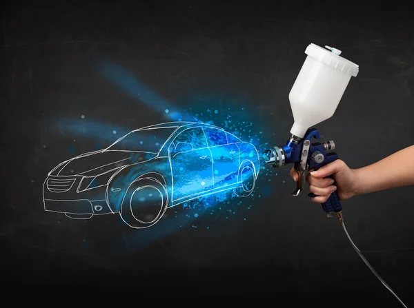 Worker with airbrush gun painting hand drawn car lines — Stock Photo, Image