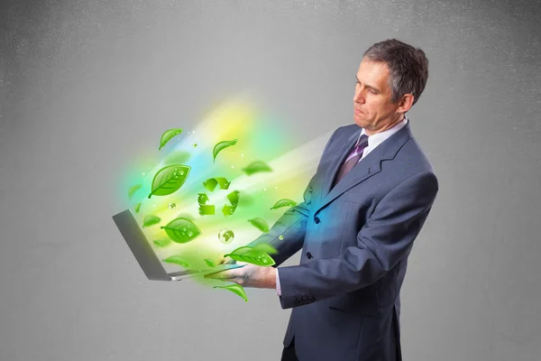 Businessman holding laptop with recycle and environmental symbo — Stock Photo, Image