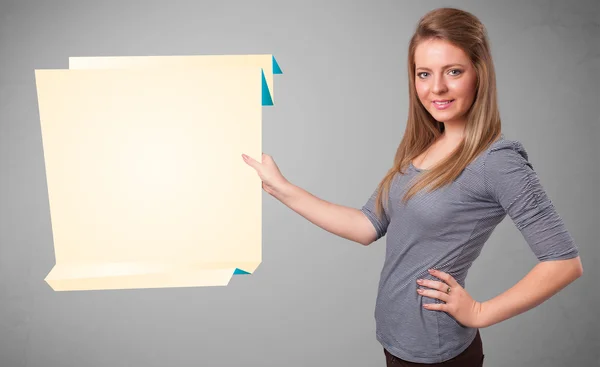 Young woman holding white origami paper copy space — Stock Photo, Image