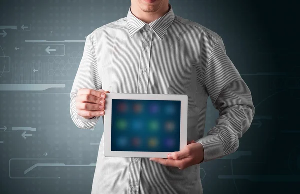 Biznesmen trzymający białą nowoczesną tabletkę z rozmytymi aplikacjami — Zdjęcie stockowe