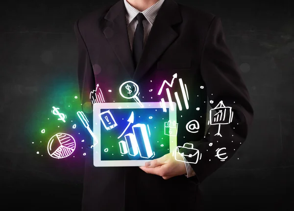 Young person holding tablet with graph and chart symbols — Stock Photo, Image