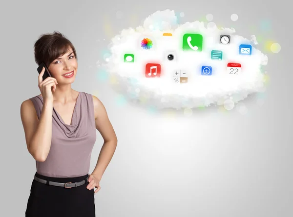 Young woman presenting cloud with colorful app icons and symbols — Stock Photo, Image