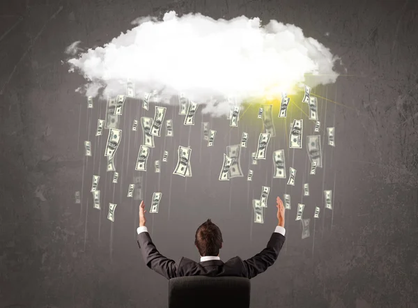 Business man in suit looking at cloud with falling money — Stock Photo, Image