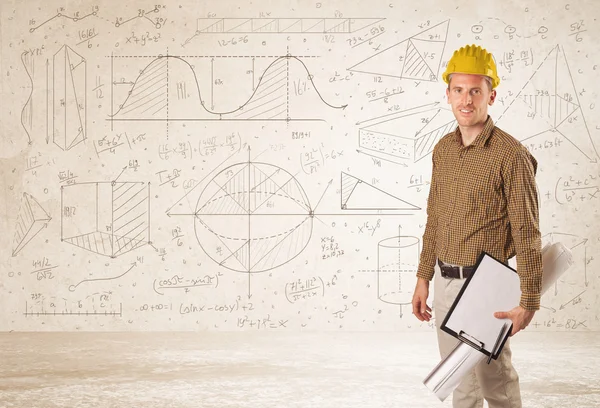 Ingeniero guapo calculando con fondo dibujado a mano — Foto de Stock