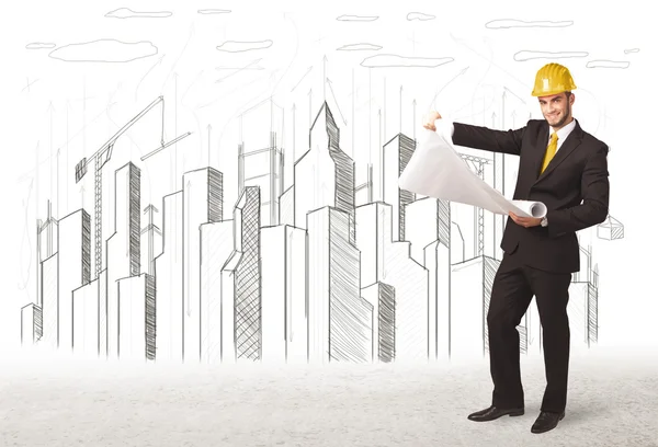 Engineer man with building city drawing in background — Stock Photo, Image