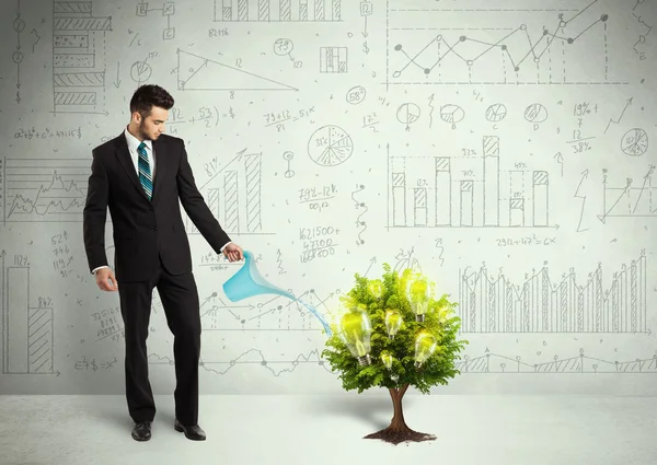 Business man pouring water on lightbulb growing tree — Stock Photo, Image