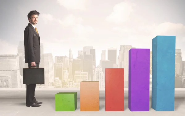 Business person climbing up on colourful chart pillars concept — Stock Photo, Image