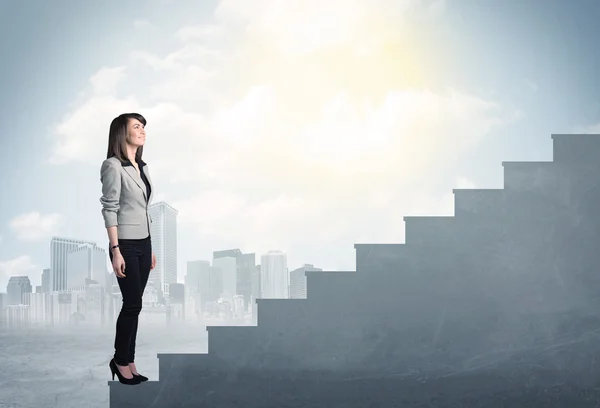 Businesswoman climbing up a concrete staircase concept — Stock Photo, Image