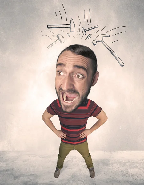 Big head person with drawn hammers — Stock Photo, Image