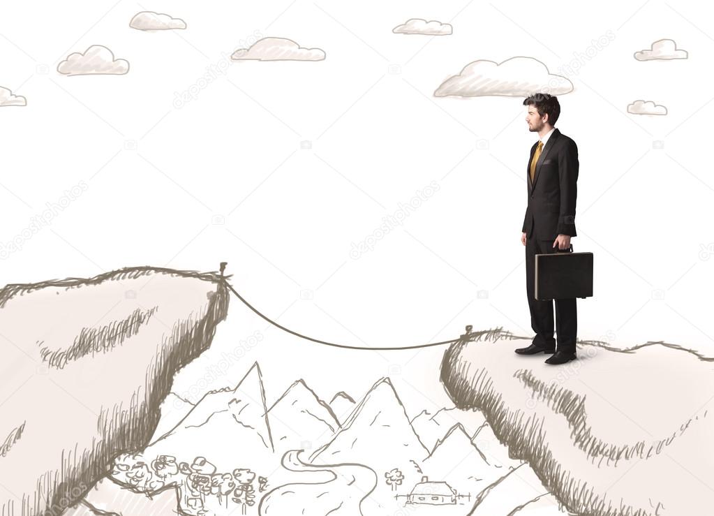 Businessman with drawn edge of mountain