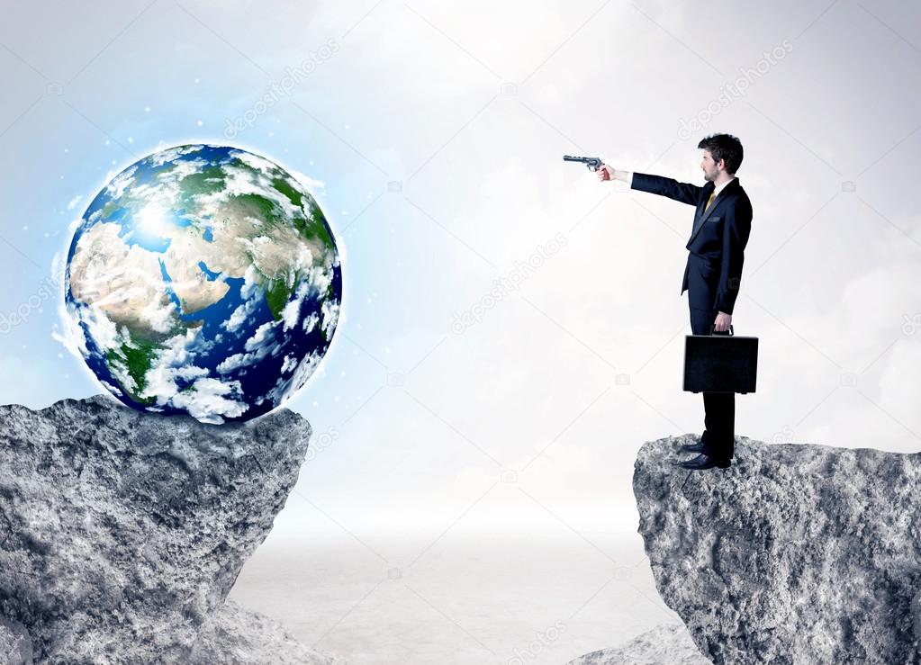 Businessman on rock mountain with a globe