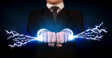 Elektrik kablolarını tutan iş adamı