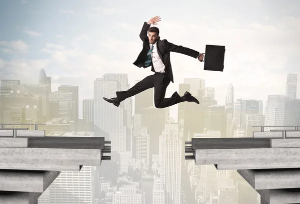 Energetic business man jumping over a bridge with gap — Stock Photo, Image