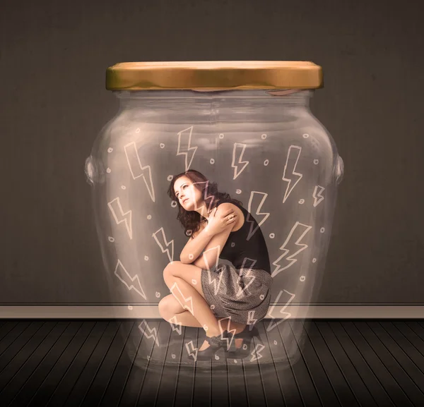 Businesswoman inside a glass jar with lightning drawings concept — Stock Photo, Image