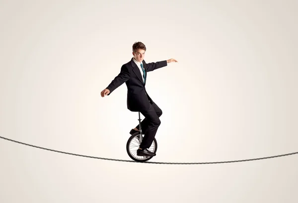 Extreme business man riding unicycle on a rope — Stock Photo, Image