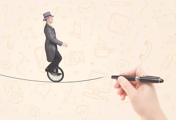 Businessman riding monocycle on a rope drawn by hand — Stock Photo, Image