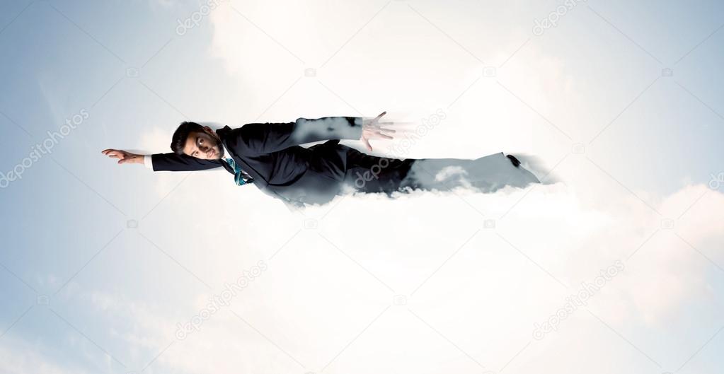 Business man flying like a superhero in clouds on the sky