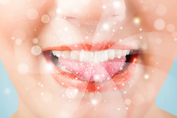 Pretty woman lips blowing abstract white lights — Stock Photo, Image