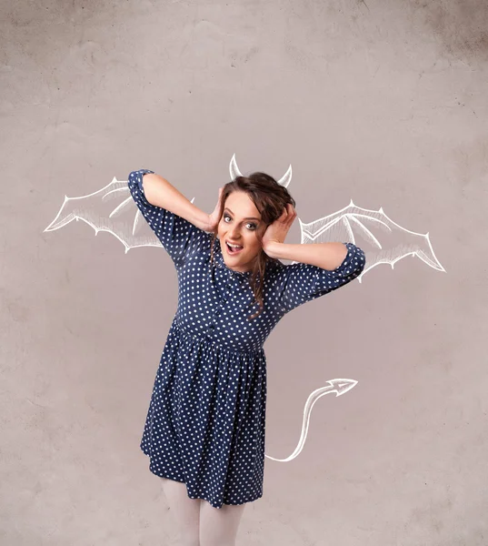 Young girl with devil horns and wings drawing — Stock Photo, Image