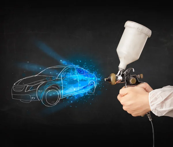 Worker with airbrush gun painting hand drawn car lines — Stock Photo, Image