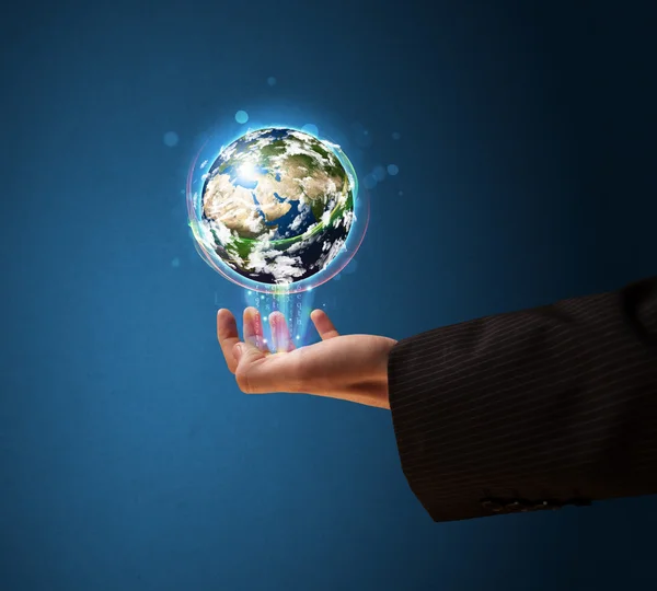 Businessman holding a glowing earth globe — Stock Photo, Image