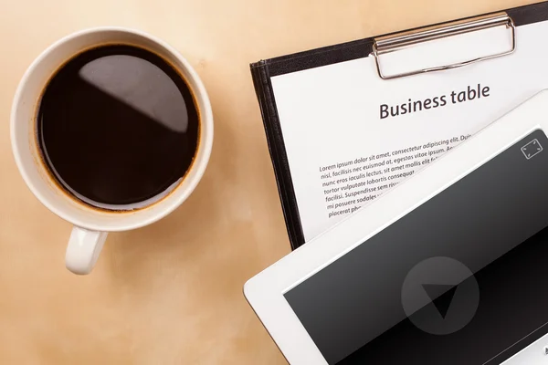 Tablet pc showing media player on screen with a cup of coffee on — Stock Photo, Image