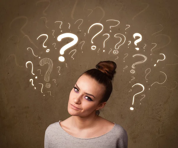 Girl with question mark symbols around her head — Stock Photo, Image