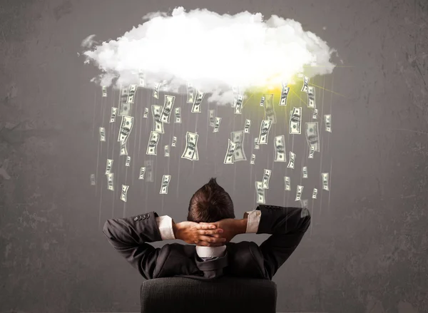 Business man in suit looking at cloud with falling money — Stock Photo, Image