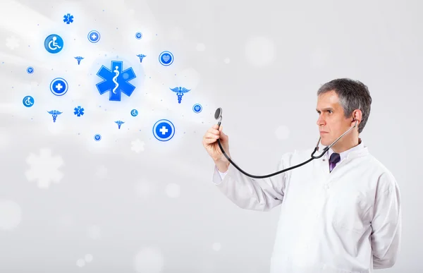 Doctor with blue medical icons — Stock Photo, Image