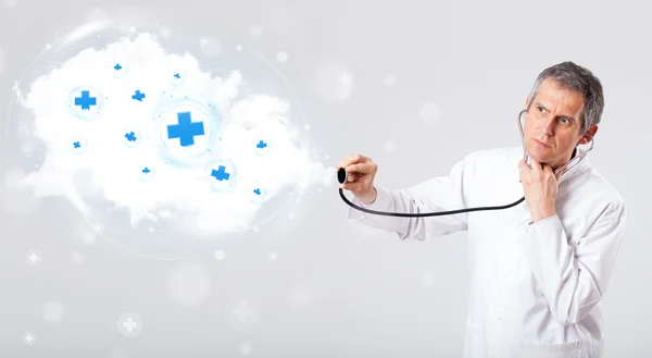 Doctor listening to abstract cloud with medical signs — Stock Photo, Image