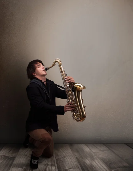 Young musician playing on saxophone — Stock Photo, Image