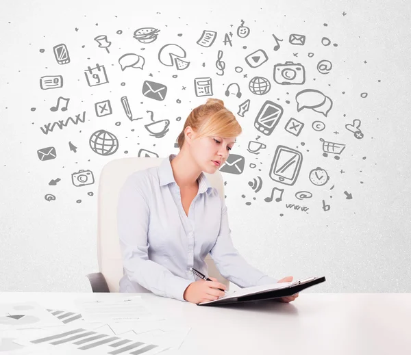 Young businesswoman with all kind of hand-drawn media icons in b — Stock Photo, Image