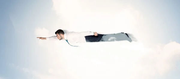 Business man flying like a superhero in clouds on the sky — Stock Photo, Image