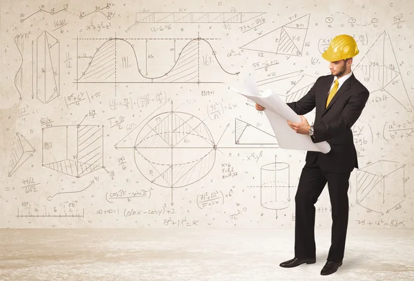 Ingeniero guapo calculando con fondo dibujado a mano —  Fotos de Stock