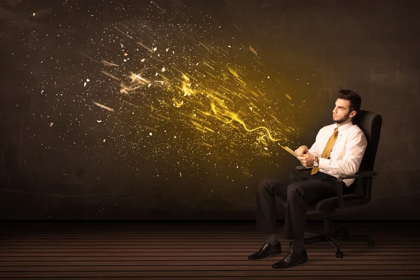 Businessman with tablet and energy explosion on background — Stock Photo, Image