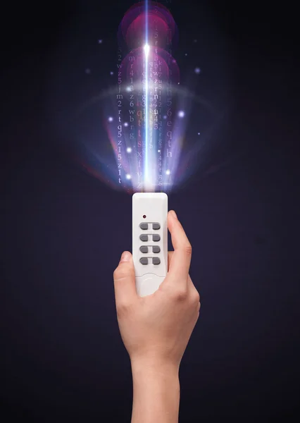 Hand with remote control and shining numbers