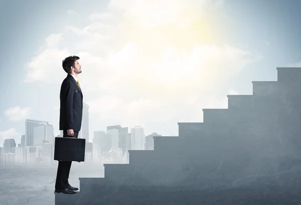 Businessman climbing up a concrete staircase concept — Stock Photo, Image