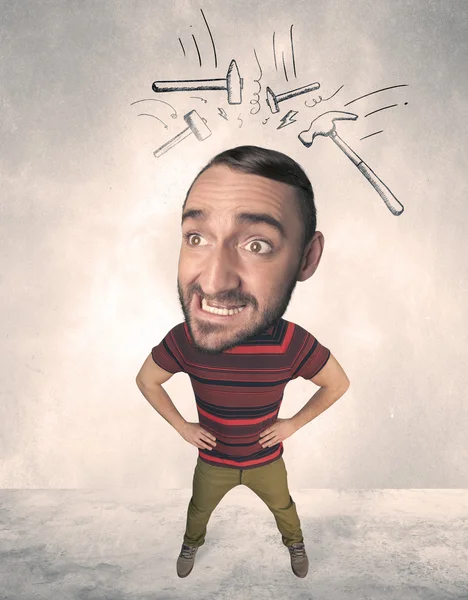 Big head person with drawn hammers — Stock Photo, Image